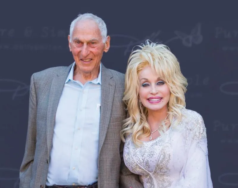 Jewish philanthropist Harold Grinspoon standing with Dolly Parton.