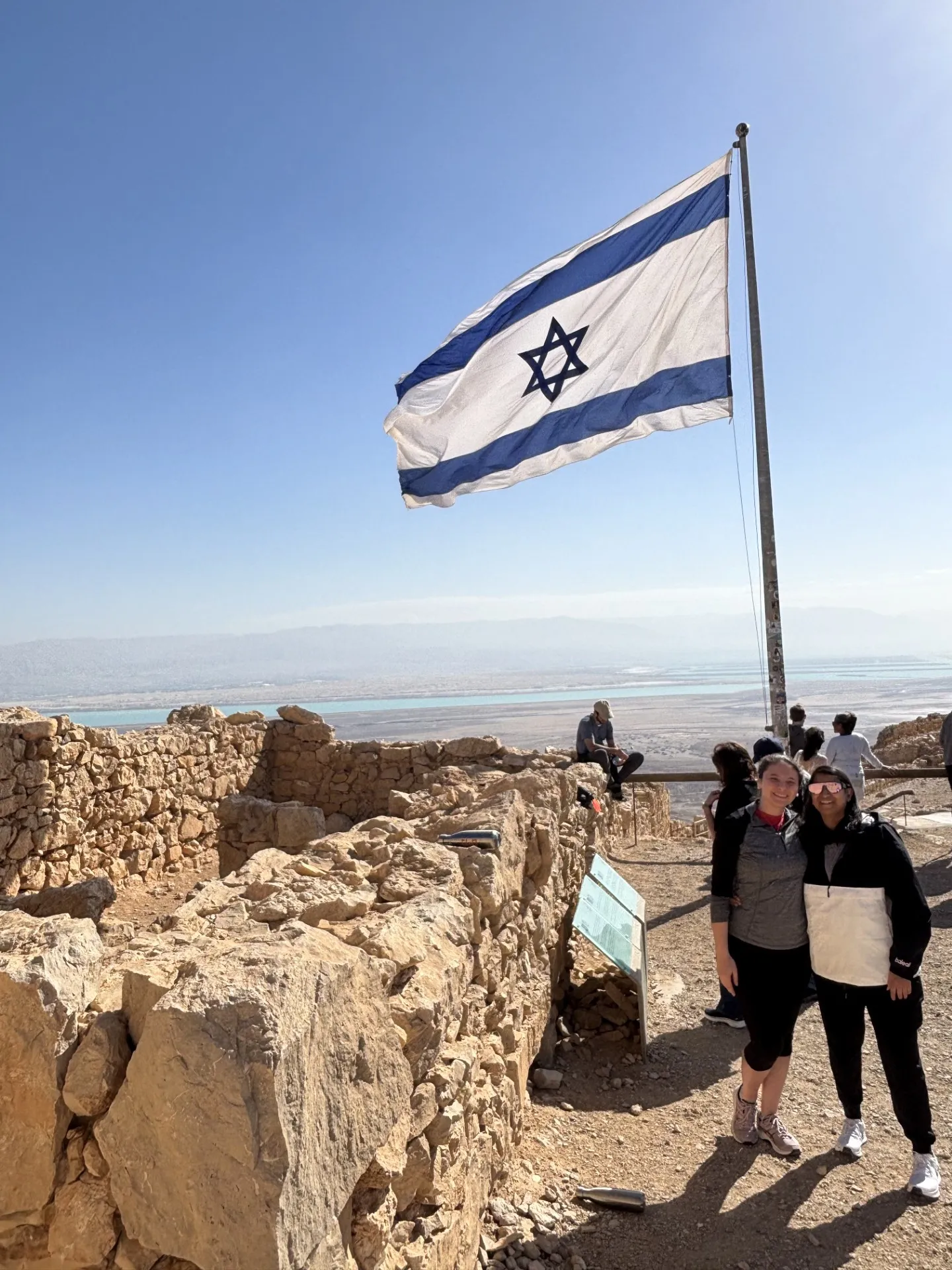 Honeymoon Israel couple from atlanta poses in front of Israel flag