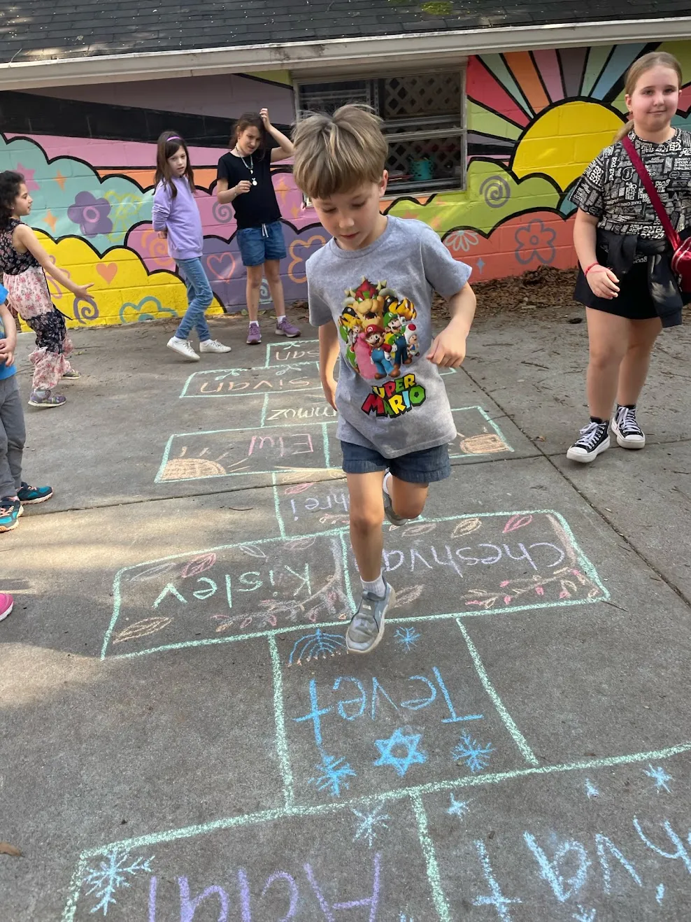 JKG kids playing hopscotch