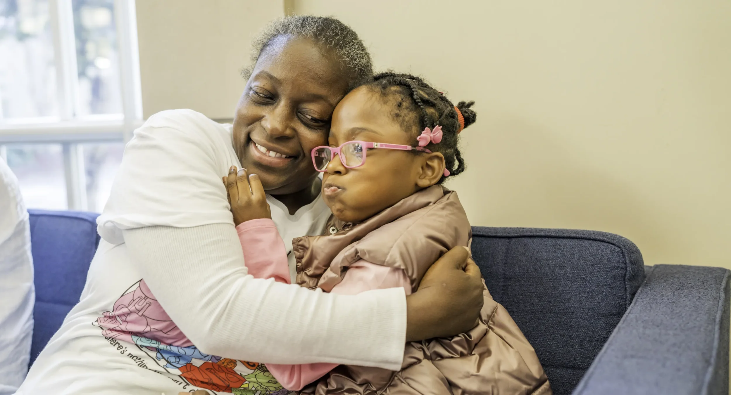 Mom hugs daughter at PJ Library event