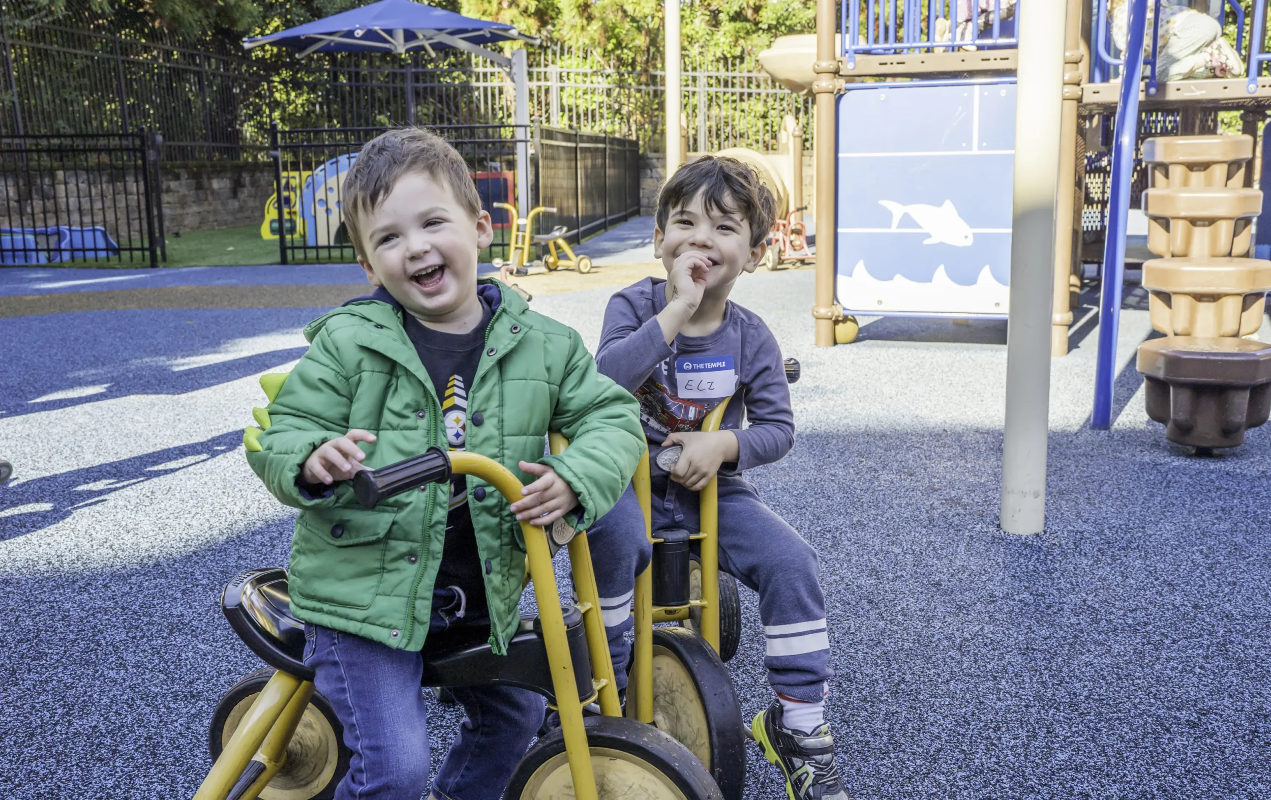 Two Boys Smiling at PJ Library Get-Together on Playground