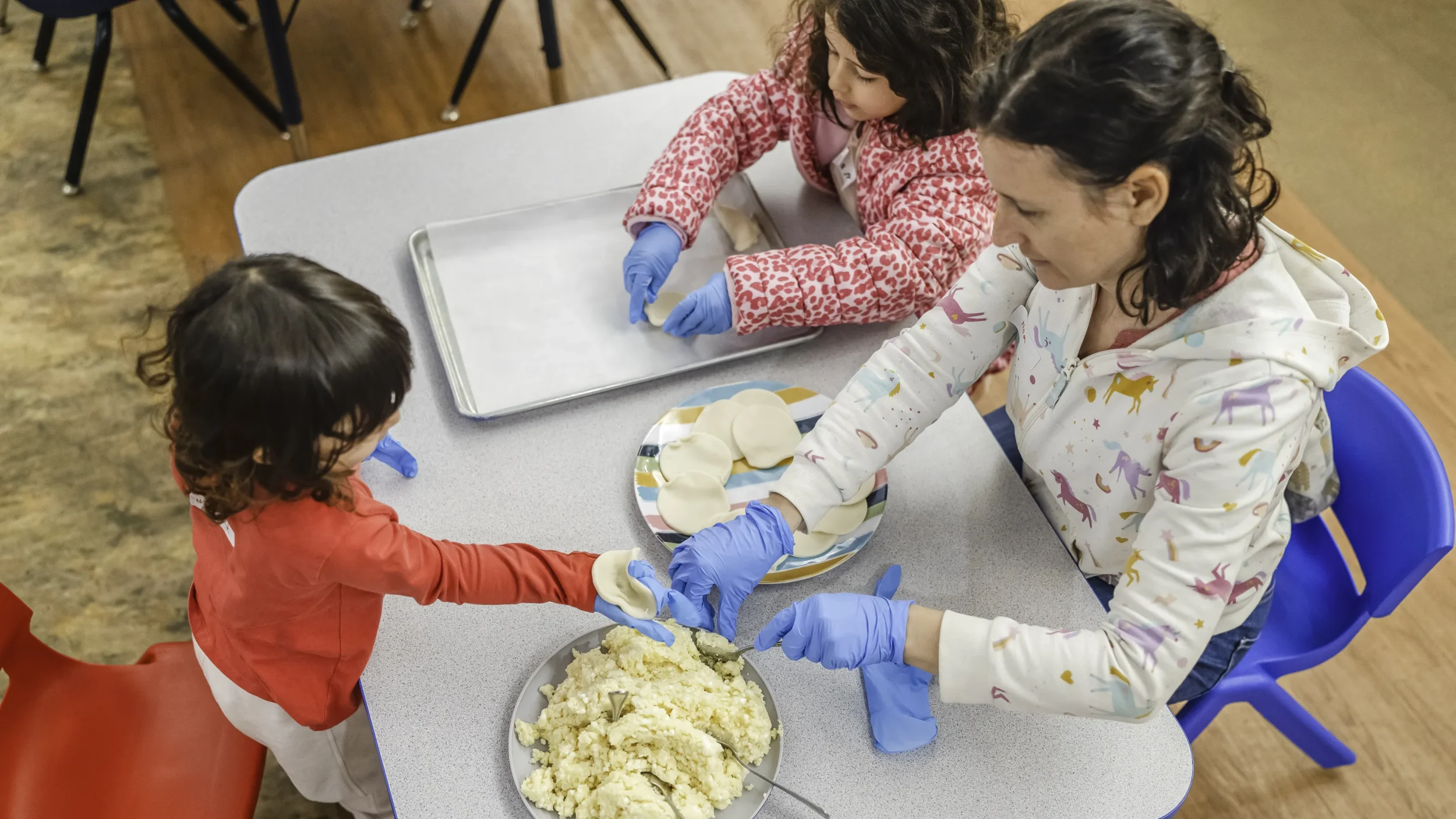 Mom with two daughters making bureka