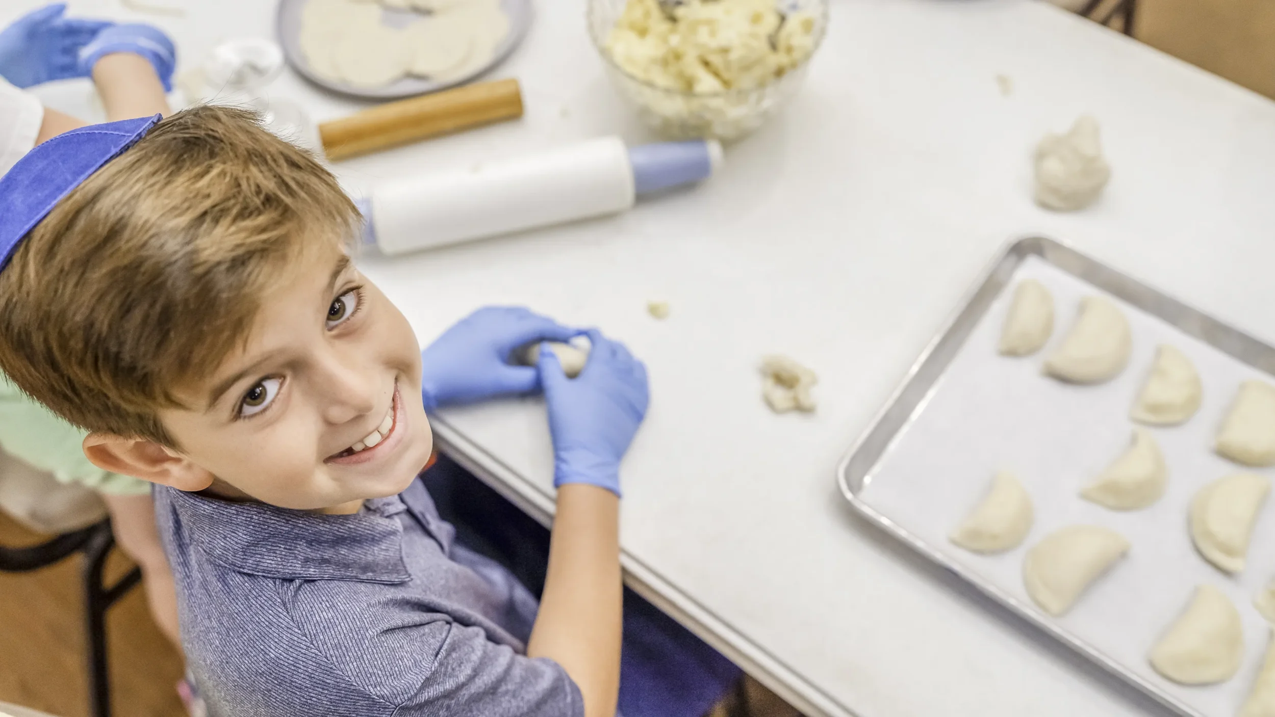Jewish boy wearing kippah and making bureka