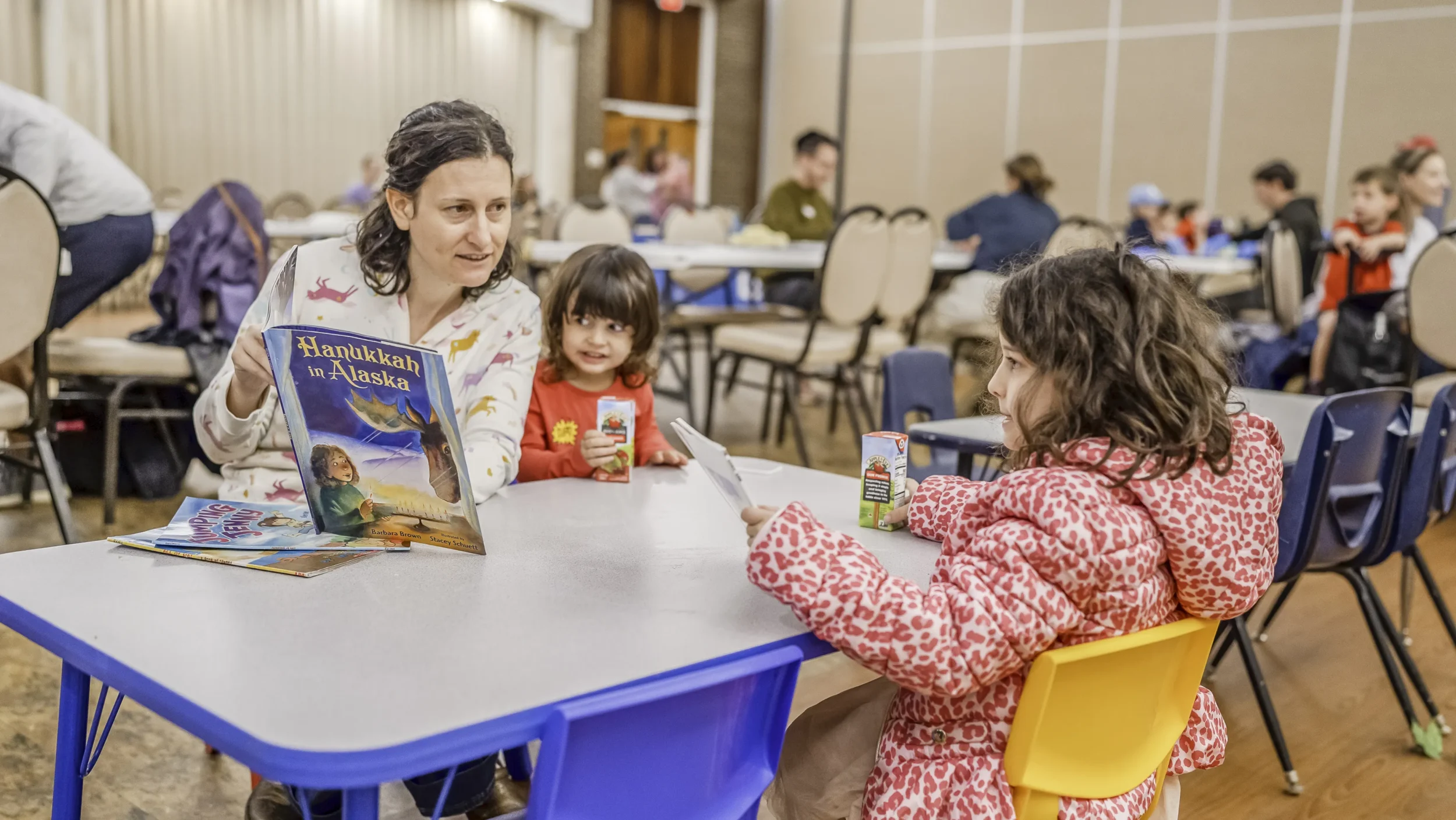 Mom with two daughters at PJ Library event for making bureka