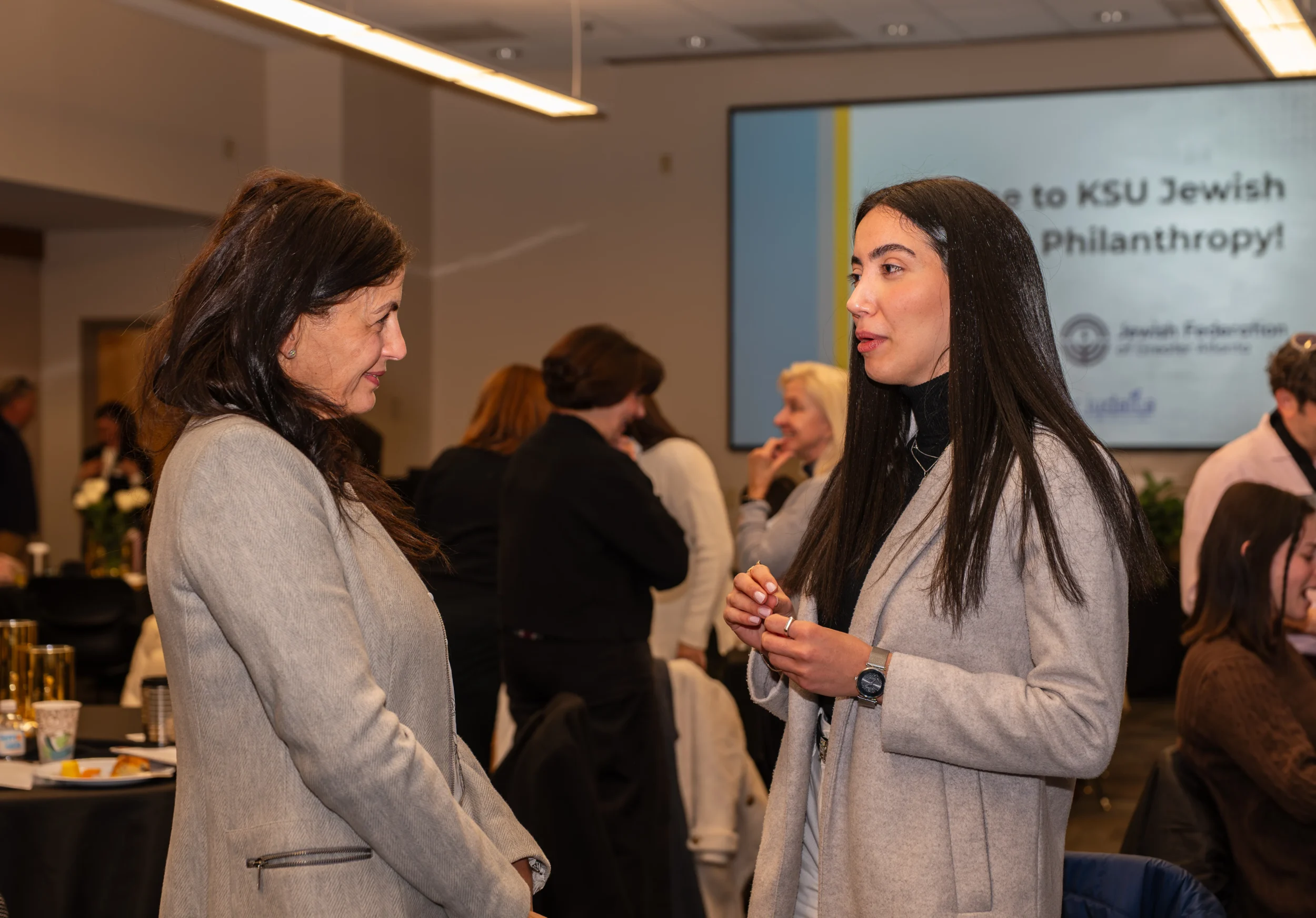 Women’s Philanthropy POP Up on Wheels Two women speaking