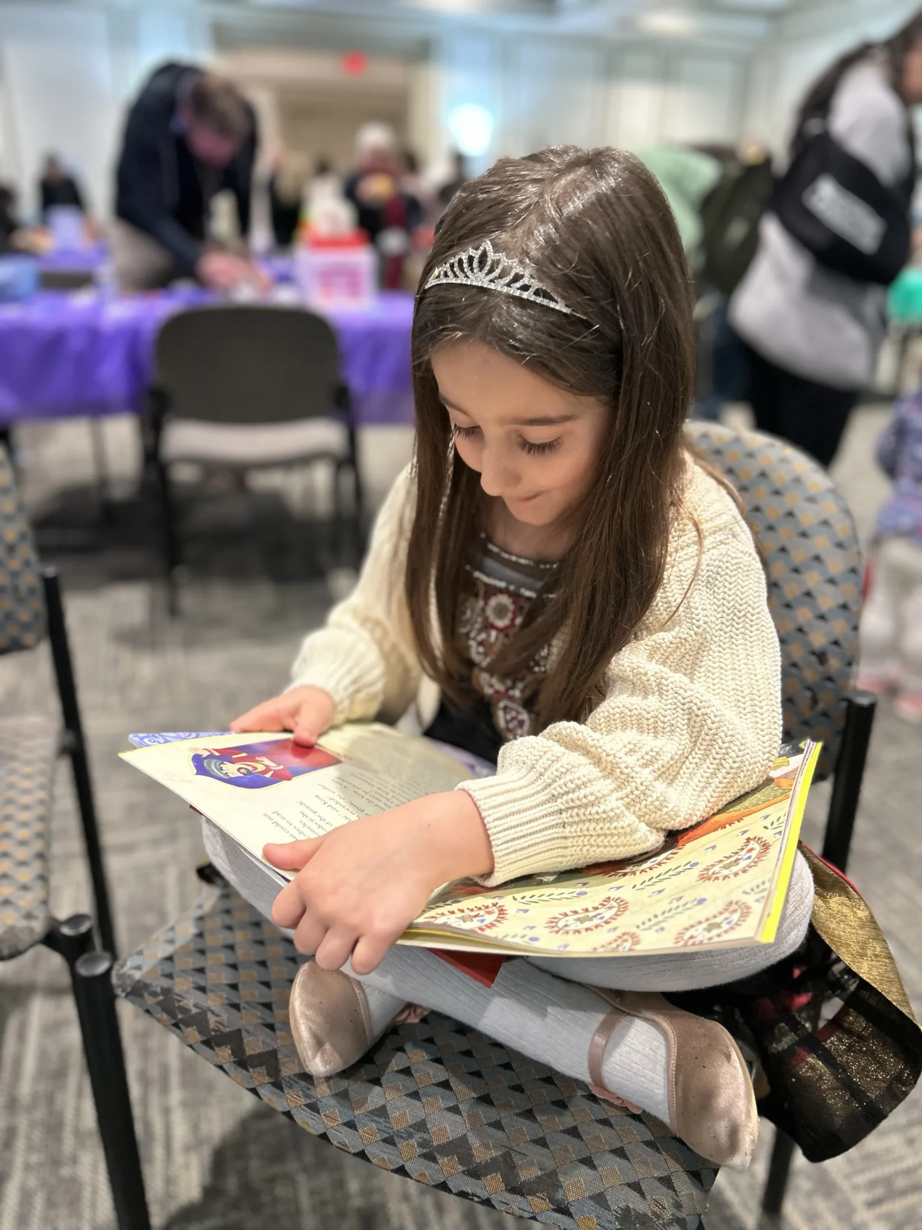 Young girl reads PJ book at PJ Event in Atlanta