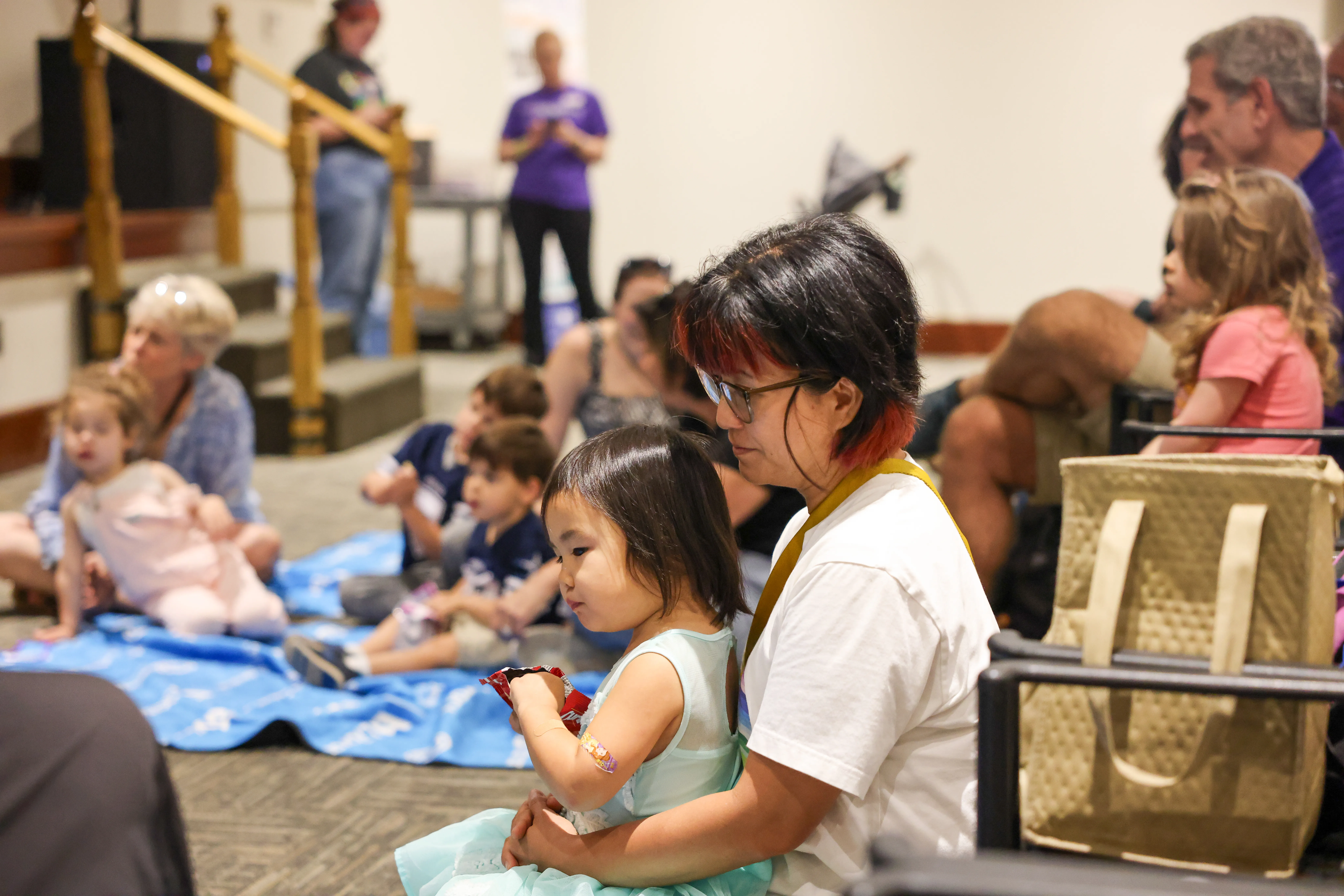 Local Atlanta mom sits with her child at PJ event