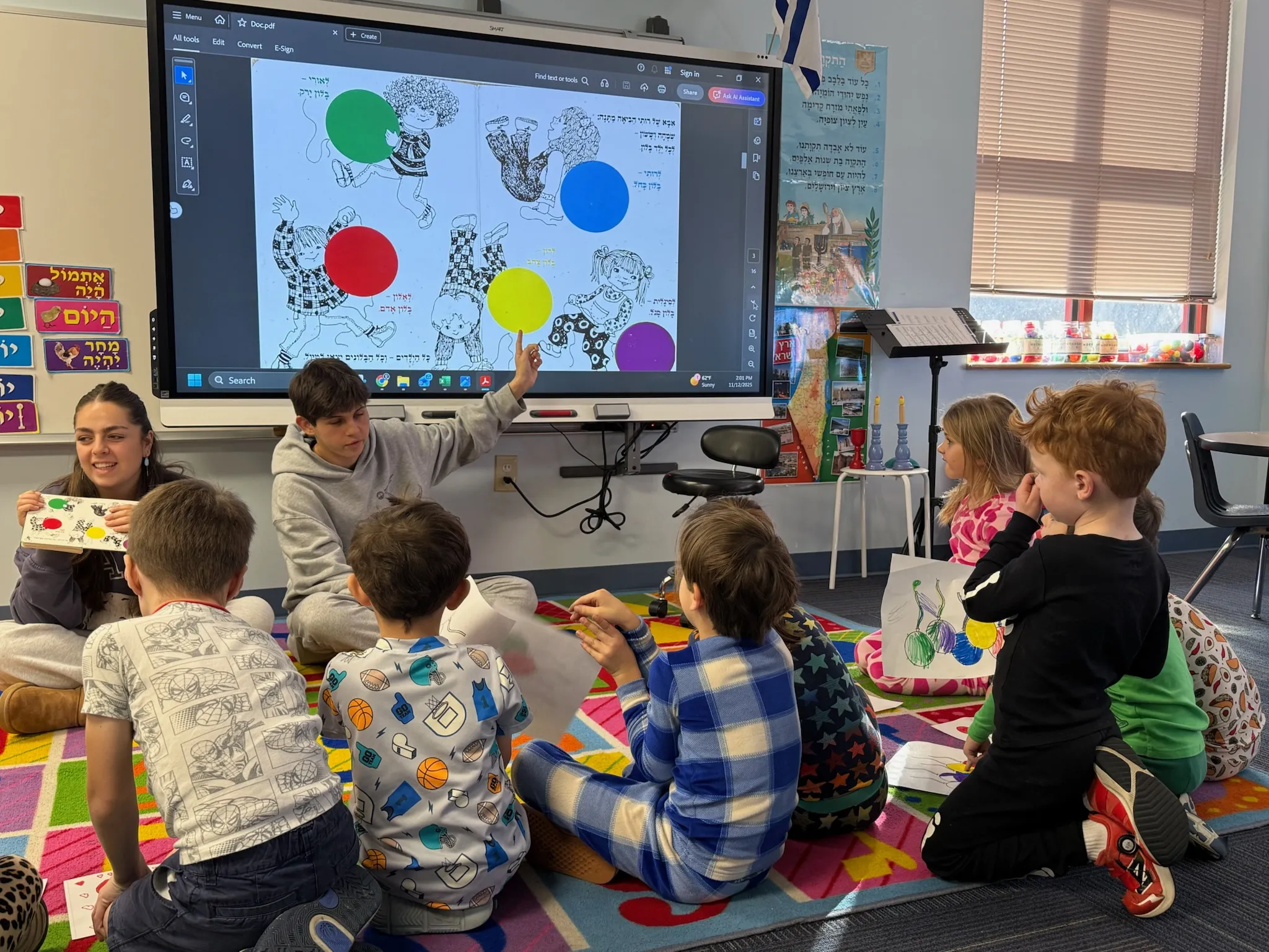 Two 2025-2026 Shinshinim with children at school