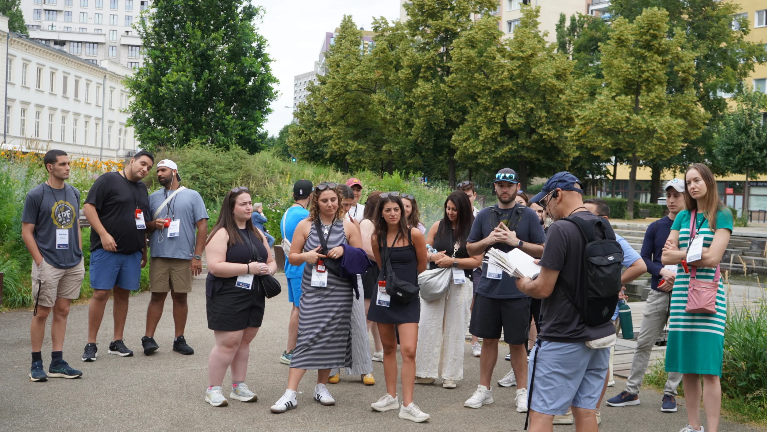 YLD Journey to Poland participants listen to a guide during an outdoor walking tour in Warsaw.