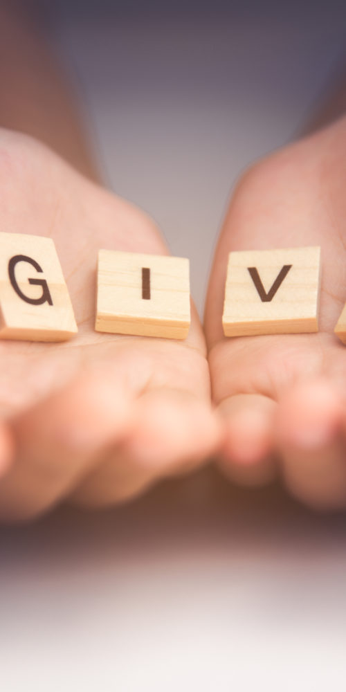give-spelled-out-scrabble-tiles-in-hands